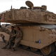 UK soldiers hang out with their tank.